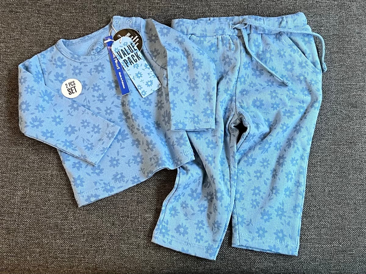 Blue ribbed 2-piece PJ set with a darker blue flower print: long-sleeve top with shoulder snaps, and drawstring trousers with pockets